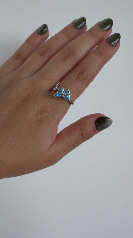 Anillo Giratorio Mariposa Plateado y Celeste — video del producto girando en la mano